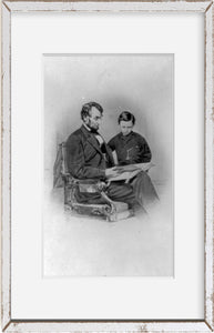 Photo: President Abraham Lincoln, his son Tad looking at an album of photographs