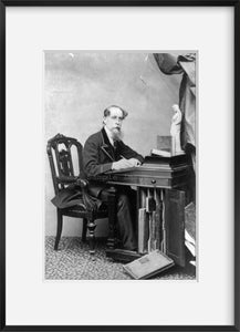 1867 photograph of Charles Dickens Summary: Full, seated at desk.