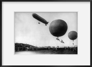 ca. 1906 photograph of Dirigible and 2 balloons aloft above crowd