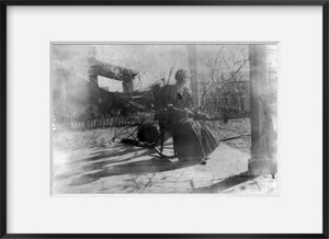 Photograph of "Our Piazza" Summary: Woman seated in rocking chair on veranda of