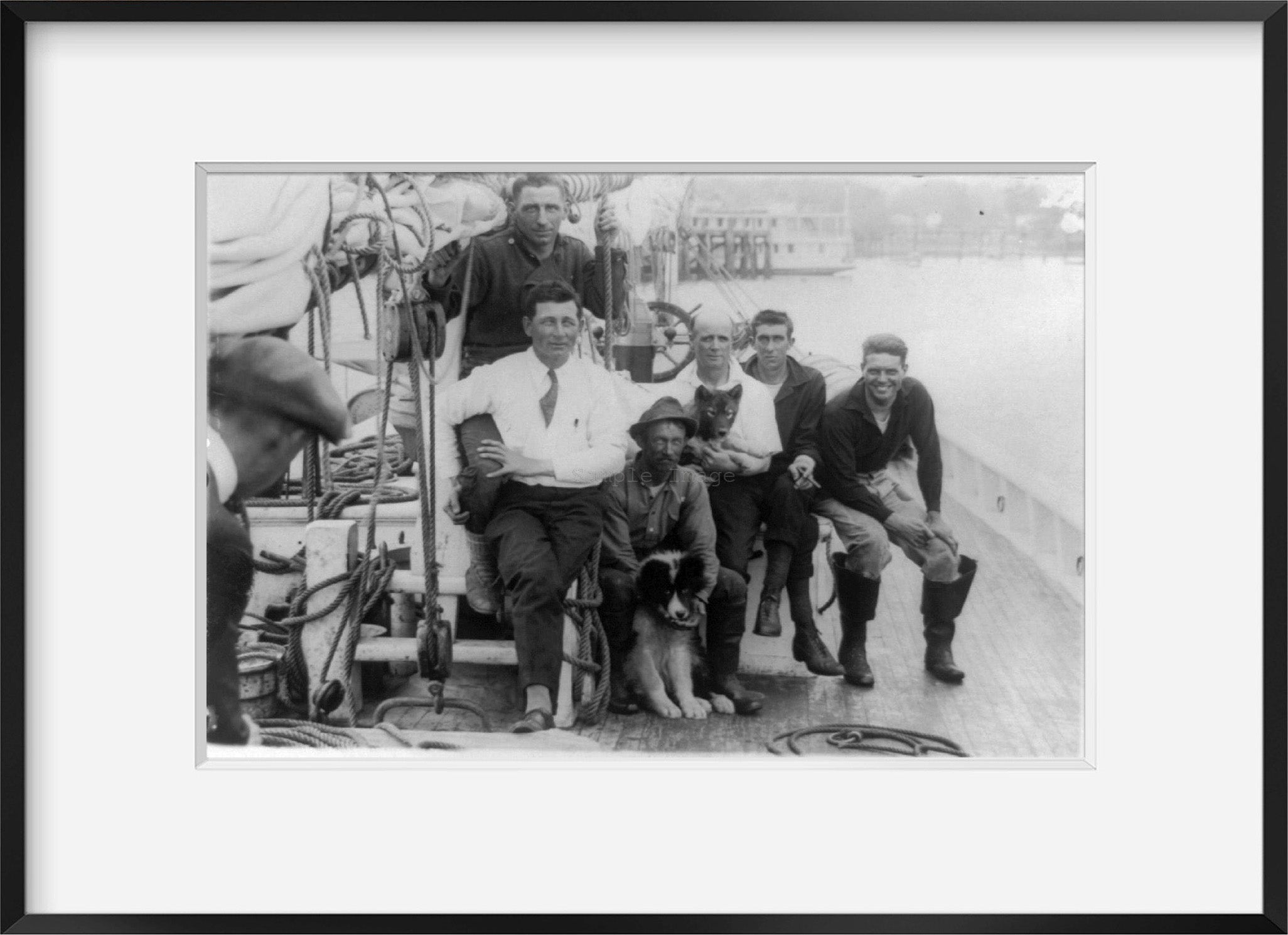 c1922 photograph of Crew of Arctic ship Bowdoin Summary: Seven men and two dogs