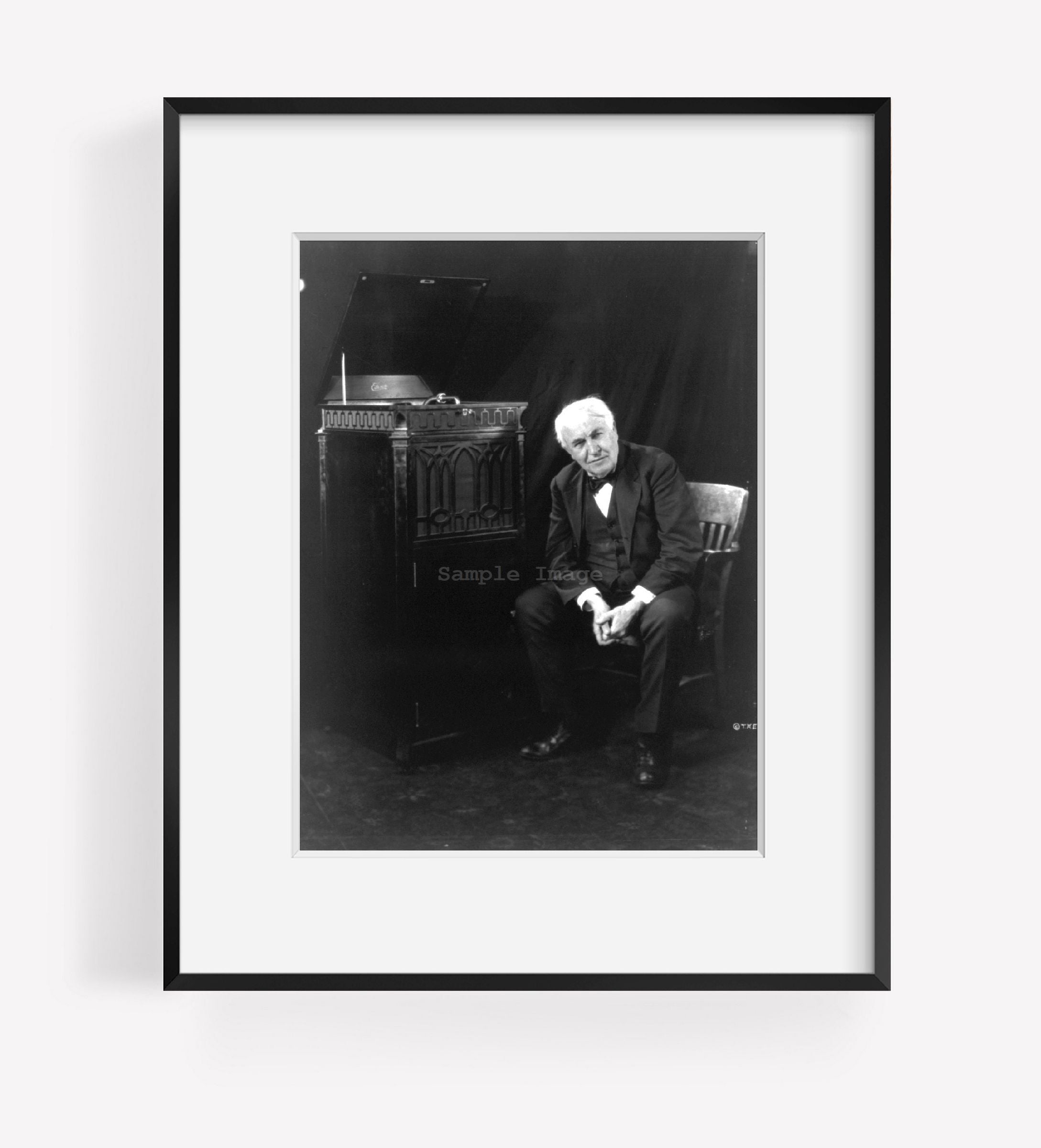 c1921 March 19 photograph of Thomas Edison, seated beside phonograph