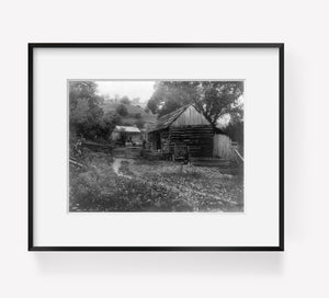Photo: Couple, carriage, log farm building, cabin, c1909