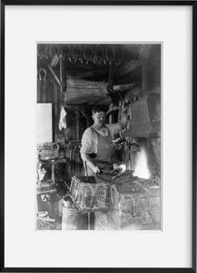 Photo: Blacksmith making a horseshoe, c1909, interior of Blacksmith shop, tools, fur