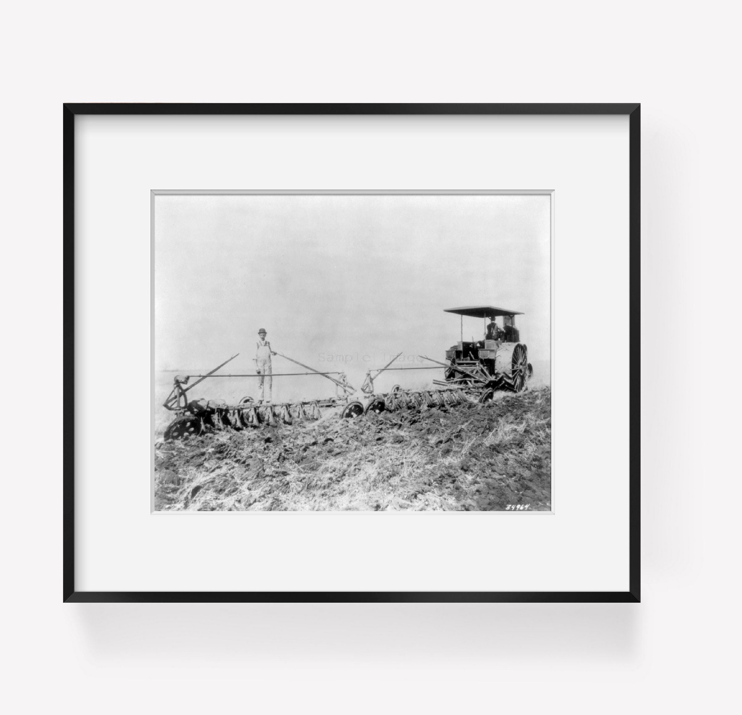 ca. 1900 photograph of Tractor pulling large set of discs across field