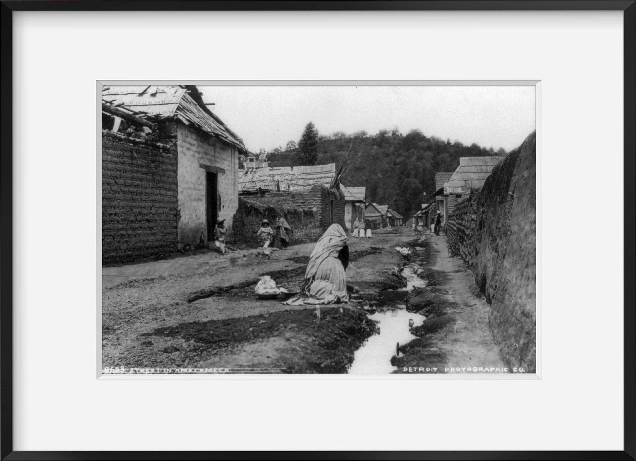 Photo: Amecameca, Mexico, woman washing clothes in stream running down street, c188