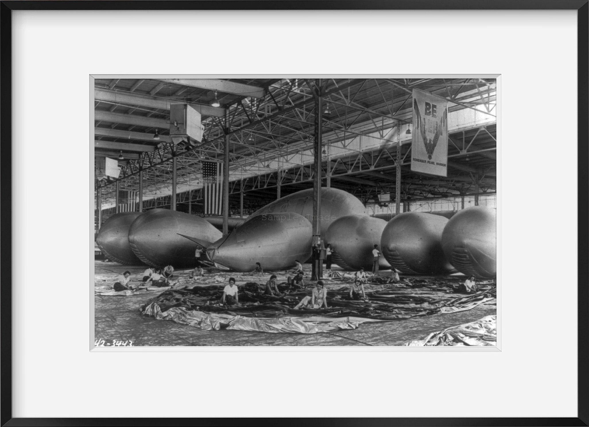 Photo: Barrage balloon seams being cemented, inspected by women war workers, c1942