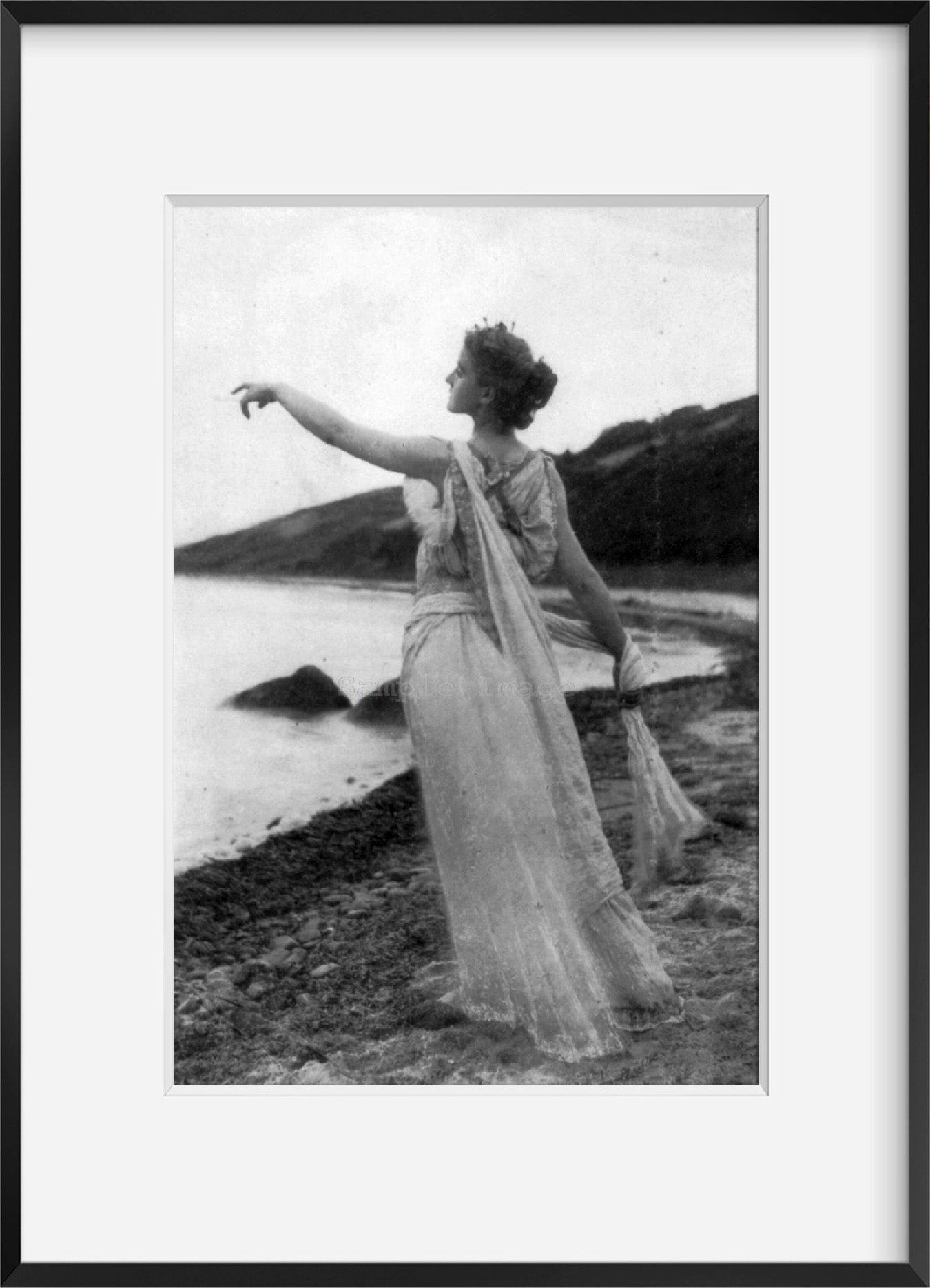 c1894 photograph of Twilight Summary: Woman in flowing dress on beach, pointing
