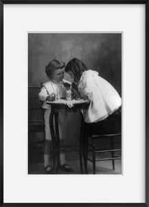 c1901 photograph of Two children at a small table sharing a soda