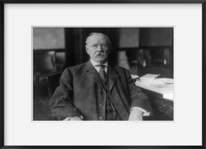 c1908 photograph of Grover Cleveland, half-length portrait, seated at desk, faci